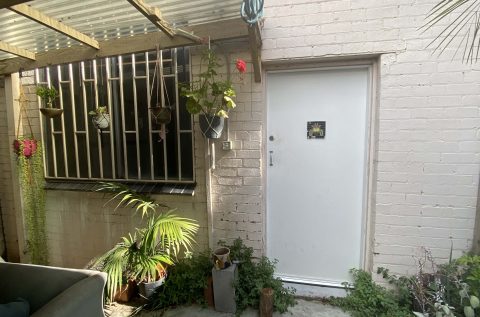 Looking from the shared garden space to the entry of the studio. 