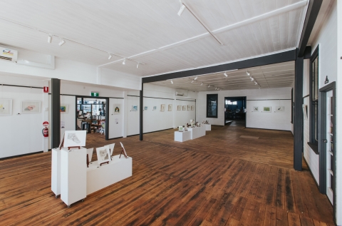 Gallery with hanging and unframed works